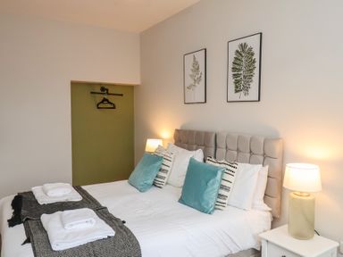 A bedroom with a bed and two lamps at The Pheasantry in Flamborough