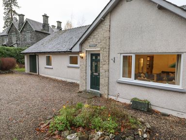 The exterior of a single story house with a garden bed and gravel driveway at Tandarra in Keswick