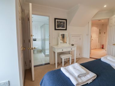 A bedroom with a bed and vanity at 9 Church Farm Rise Aldeburgh