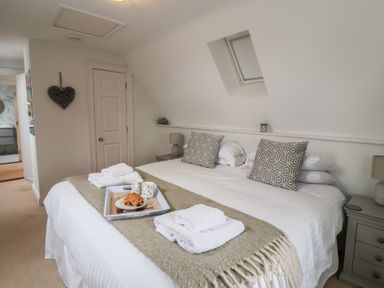 A bedroom with a double bed and side table at 9 Church Farm Rise Aldeburgh