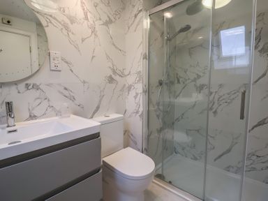 A bathroom with a shower and sink at 9 Church Farm Rise Aldeburgh
