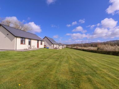 A view of houses and lawn at Country Cottage in Brecon
