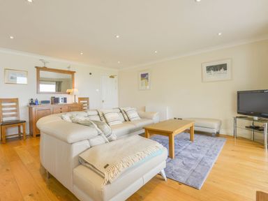 A living room with a white couch and wooden coffee table at 19 Burgh Island Causeway in Bigbury-On-Sea