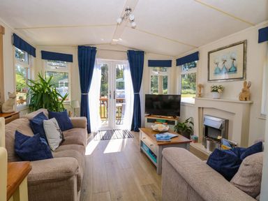 A snug with a sofa and television at 25 Foxburrow Hang in Fritton near Belton