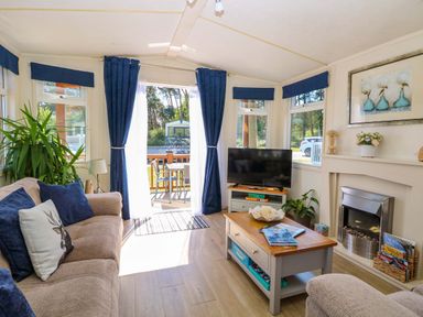 A snug with a television and a coffee table at 25 Foxburrow Hang in Fritton near Belton