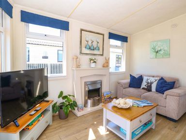 A living room with a television and a coffee table at 25 Foxburrow Hang in Fritton near Belton