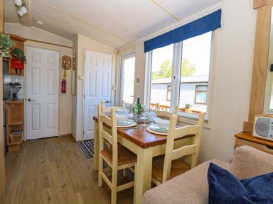A dining area with a table and chairs at 25 Foxburrow Hang in Fritton near Belton