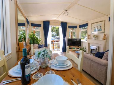 A living room with dining area and television at 25 Foxburrow Hang in Fritton near Belton