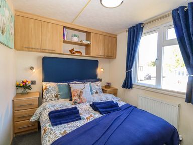 A bedroom with a bed and shelving at 25 Foxburrow Hang in Fritton near Belton