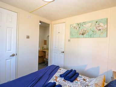 A bedroom with a bed and a vanity at 25 Foxburrow Hang in Fritton near Belton