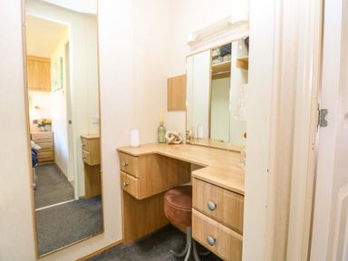 A dressing room with a vanity table and chair at 25 Foxburrow Hang Fritton near Belton