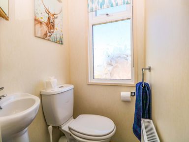 A bathroom with a toilet and sink at 25 Foxburrow Hang in Fritton near Belton