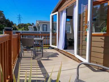 An outdoor area with a deck, table, and chairs at 25 Foxburrow Hang in Fritton near Belton
