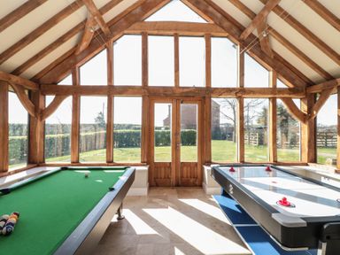 A game room with a pool table and an air hockey table at The Barn Helperby near Boroughbridge