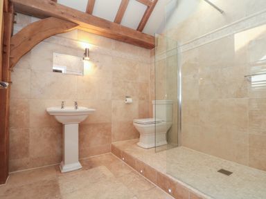 A bathroom with a pedestal sink toilet and walk in shower at The Barn Helperby near Boroughbridge