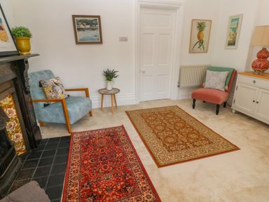 A sitting room with two armchairs and two rugs at Hindon Hall in Lelant near Carbis Bay