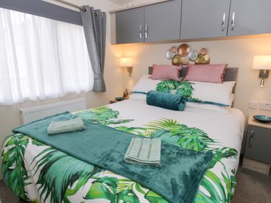 A bedroom with a bed and decorative items at The Haven 