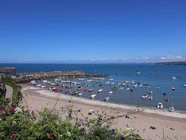 A beach with boats and a pier at The Haven in 