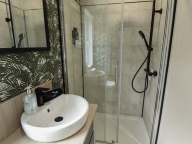 A bathroom with a sink and shower at Heather William Lodge near Woodhall Spa