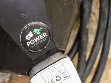 Close up of an electrical device with a Power and Protect sticker and a cable attached