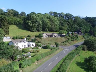 A road with houses and greenery on either side at Curtau Llanfaredd near Builth Wells