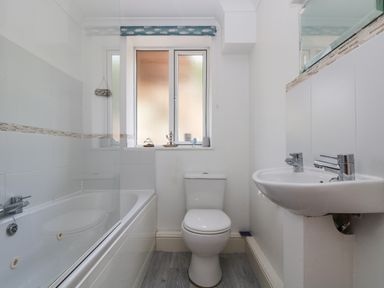 A bathroom with a bathtub a toilet and a sink at Godrevy in Porthcurno
