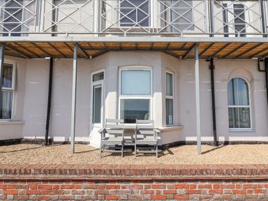 An outdoor area with gravel and a seating set at 11 The Craighurst Southwold