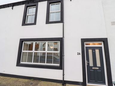 The exterior of a white building with black window frames and a black door labeled 2a at 2A Front Street in Embleton