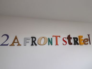 Letters on a white wall spelling 2A FRONT STREET at 2A Front Street in Embleton