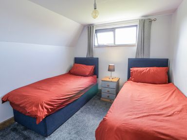 A bedroom with two beds and a nightstand at Valley View Hideaway in Ffostrasol