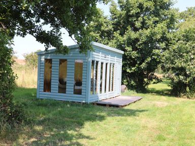 A cabin with large windows and a deck at Holmside Audley Brow near Market Drayton
