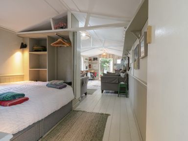 A bedroom with a bed and seating area at The Artist's Cabin By The Sea Herne Bay