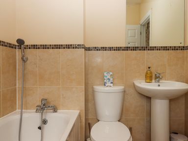 A bathroom with a bathtub shower toilet and pedestal sink at Culver Court Cottage in Venny Tedburn near Crediton