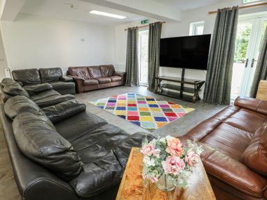 A living room with sofas and a television at The Bevan in Bontnewydd, Gwynedd