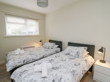 A bedroom with two single beds each with animal print bedding at 36 Coedrath Park in Saundersfoot