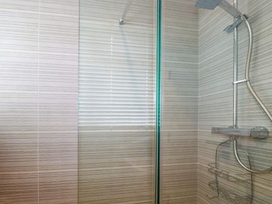 A shower area with a rainfall showerhead and a handheld shower at Polwen in Harlyn Bay Padstow