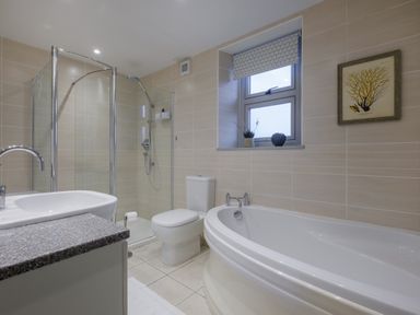 A bathroom with a shower enclosure bathtub toilet and sink at Sunny Brae in Lindale