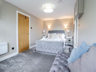A bedroom with a bed and bedside table at Hafod Y Bryn in Harlech