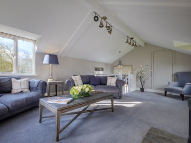 A living room with two sofas a coffee table and a window at Gate House in Killington near Sedbergh