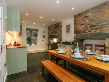 A kitchen with a dining table and chairs at Ty Capel Bethania in Nant Gwynant