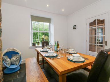 A dining room with a table set for a meal at Ty Capel Bethania Nant Gwynant