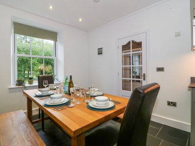 A dining room with a table set for a meal at Ty Capel Bethania Nant Gwynant