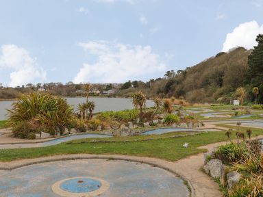 Outdoor mini golf course near a lake with plants and trees at Lakeside in Falmouth
