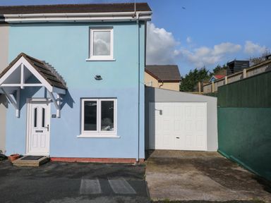 A house with a white front door and garage at No.22 The Clicketts Tenby