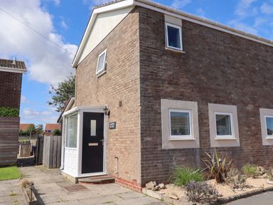 A house exterior with a door and windows at Lavender Cottage in Beadnell