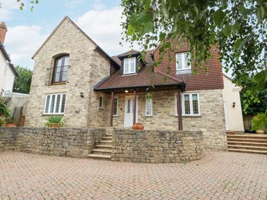 The exterior of a stone house with multiple windows and a tiled roof at Sunningdale Rise in Preston