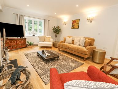 A living room with sofas coffee table and television at Sunningdale Rise in Preston