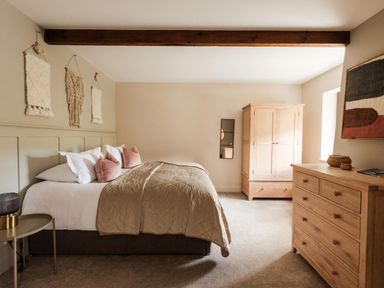 A bedroom with a bed and wardrobe at Lower Well Farm House in Totnes