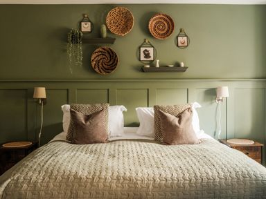 A bedroom with a bed and wall decor at Lower Well Farm House in Totnes