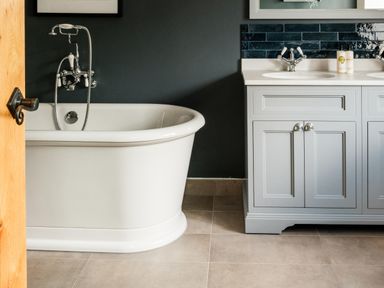 A bathroom with a bathtub and sink at Lower Well Farm House in Totnes